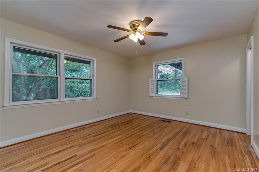 81 Jericho Drive Tryon, NC 28782 - Photo 16 of 23 a view of an empty room with wooden floor and a window