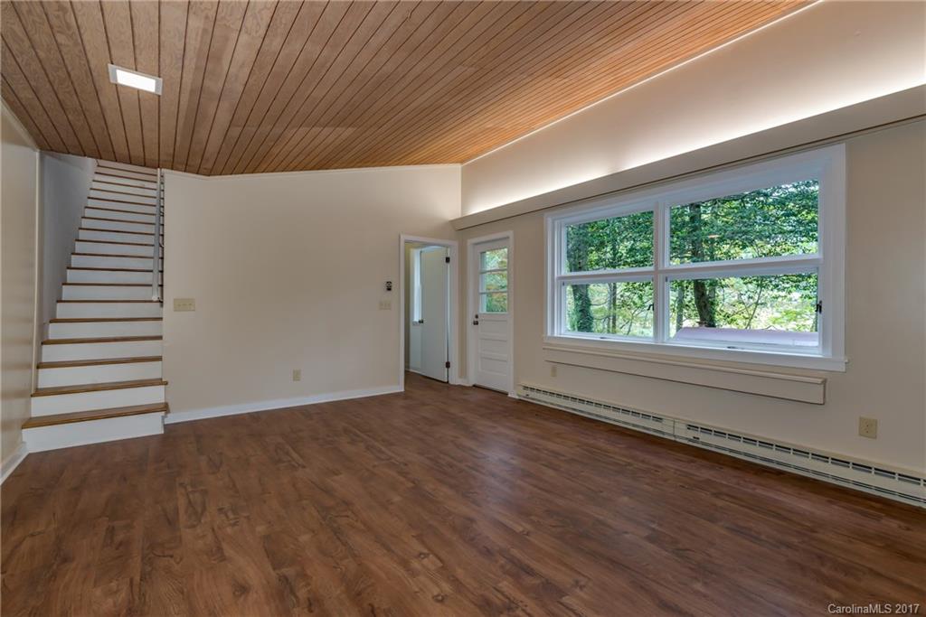 81 Jericho Drive Tryon, NC 28782 - Photo 17 of 23 an empty room with wooden floor and windows