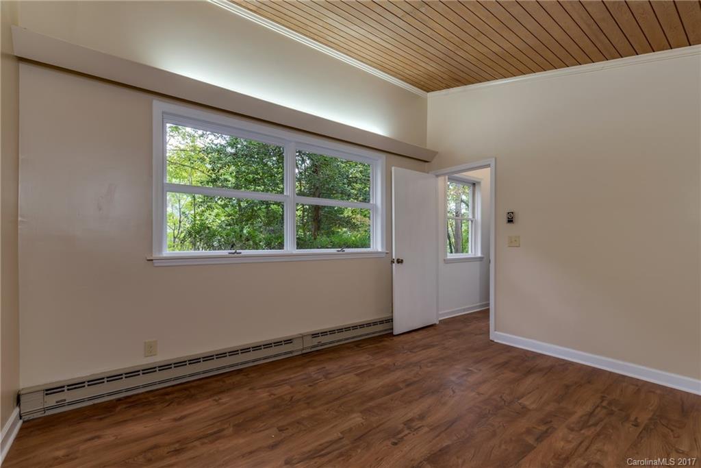 81 Jericho Drive Tryon, NC 28782 - Photo 20 of 23 an empty room with wooden floor and windows