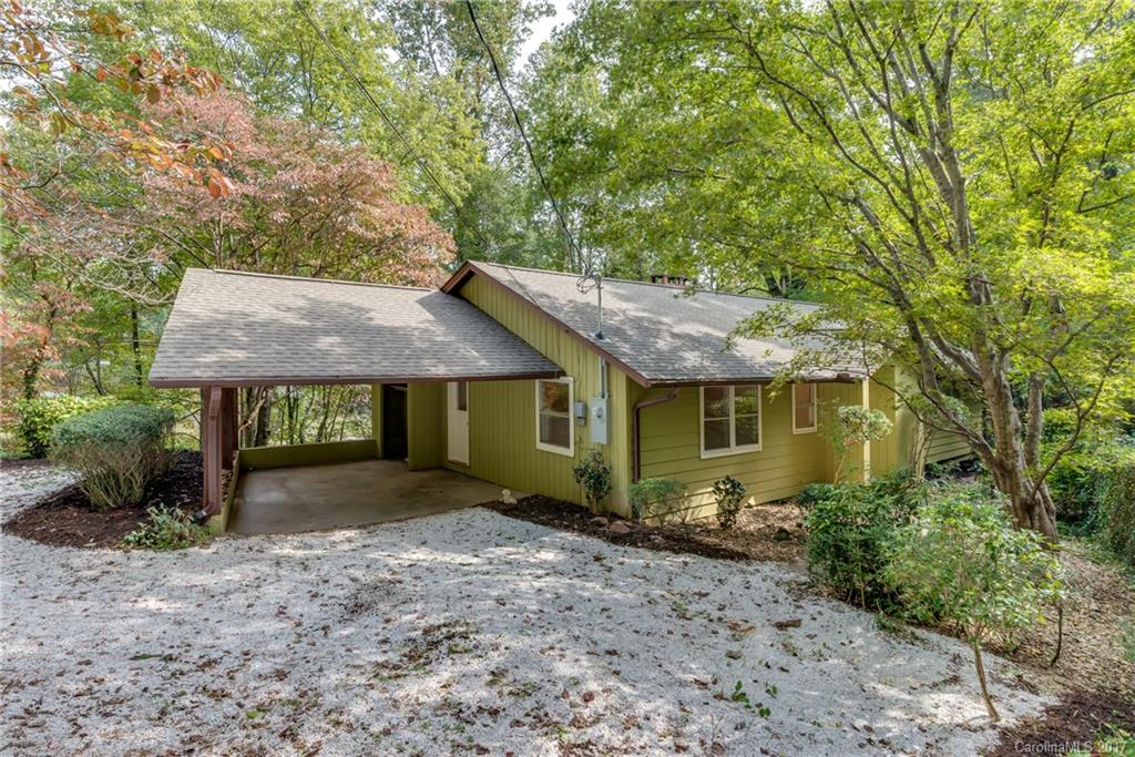 81 Jericho Drive Tryon, NC 28782 - Photo 22 of 23 a view of a house with a garden and trees
