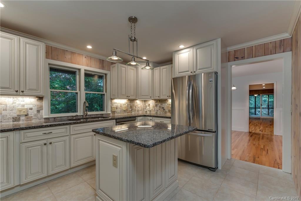 81 Jericho Drive Tryon, NC 28782 - Photo 7 of 23 a kitchen with stainless steel appliances granite countertop a sink and a refrigerator