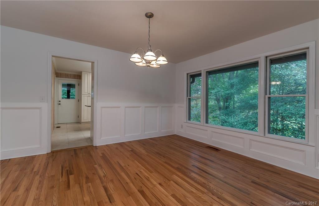 81 Jericho Drive Tryon, NC 28782 - Photo 8 of 23 a view of empty room with wooden floor and fan