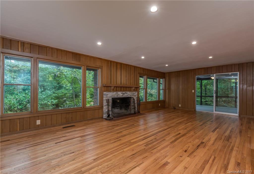 81 Jericho Drive Tryon, NC 28782 - Photo 9 of 23 a view of empty room with wooden floor and fireplace