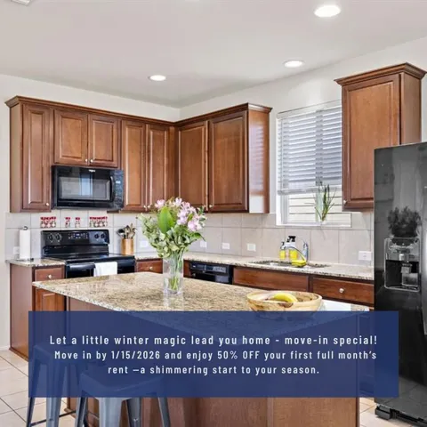 a kitchen with stainless steel appliances granite countertop a stove a sink cabinets and a counter top space