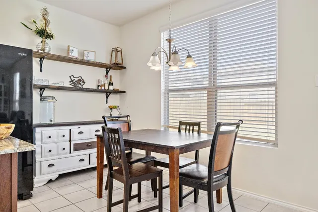 a view of a dining room with furniture and chandelier