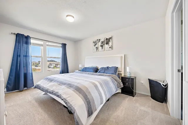 a bedroom with a large bed and a chandelier