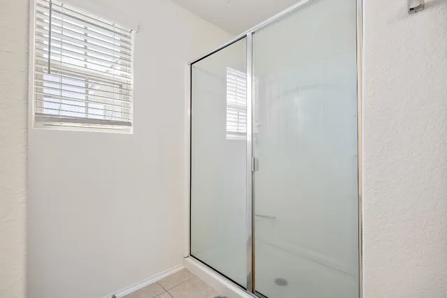 a bathroom with a glass shower door