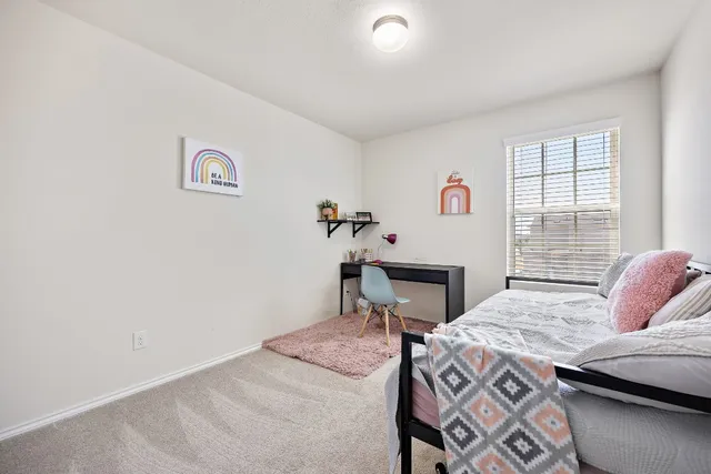 a bedroom with a bed and a table in it