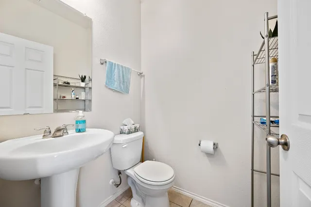 a bathroom with a sink toilet and a mirror