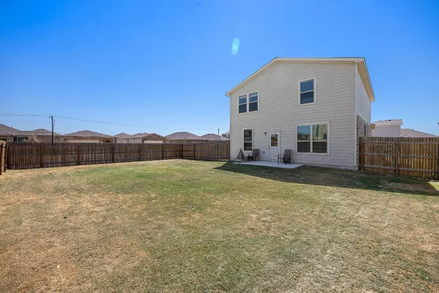 a view of a house with backyard and deck