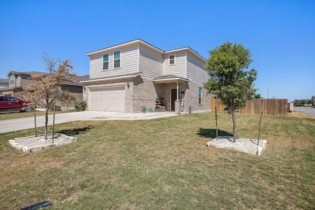 a front view of a house with a yard