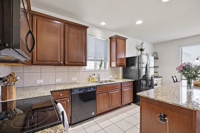 a kitchen with a sink stove and cabinets