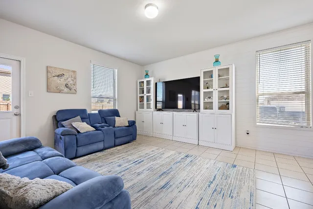 a living room with furniture and flat screen tv