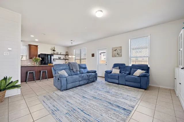 a living room with a couch and a view of kitchen