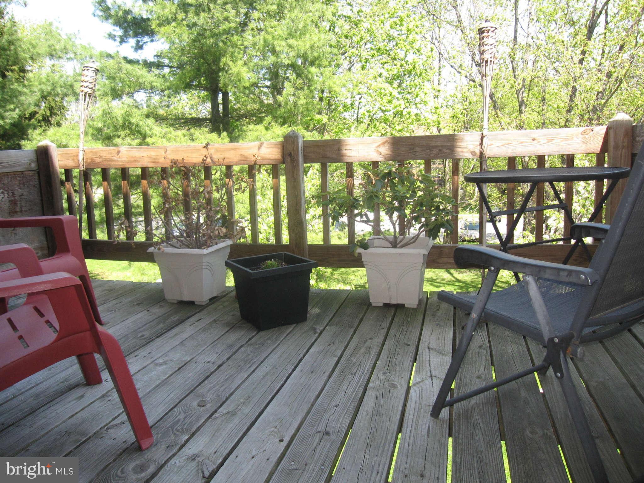 89 Valley Ridge Loop Cockeysville, MD 21030 - Photo 2 of 16 a view of a balcony with chairs and wooden floor
