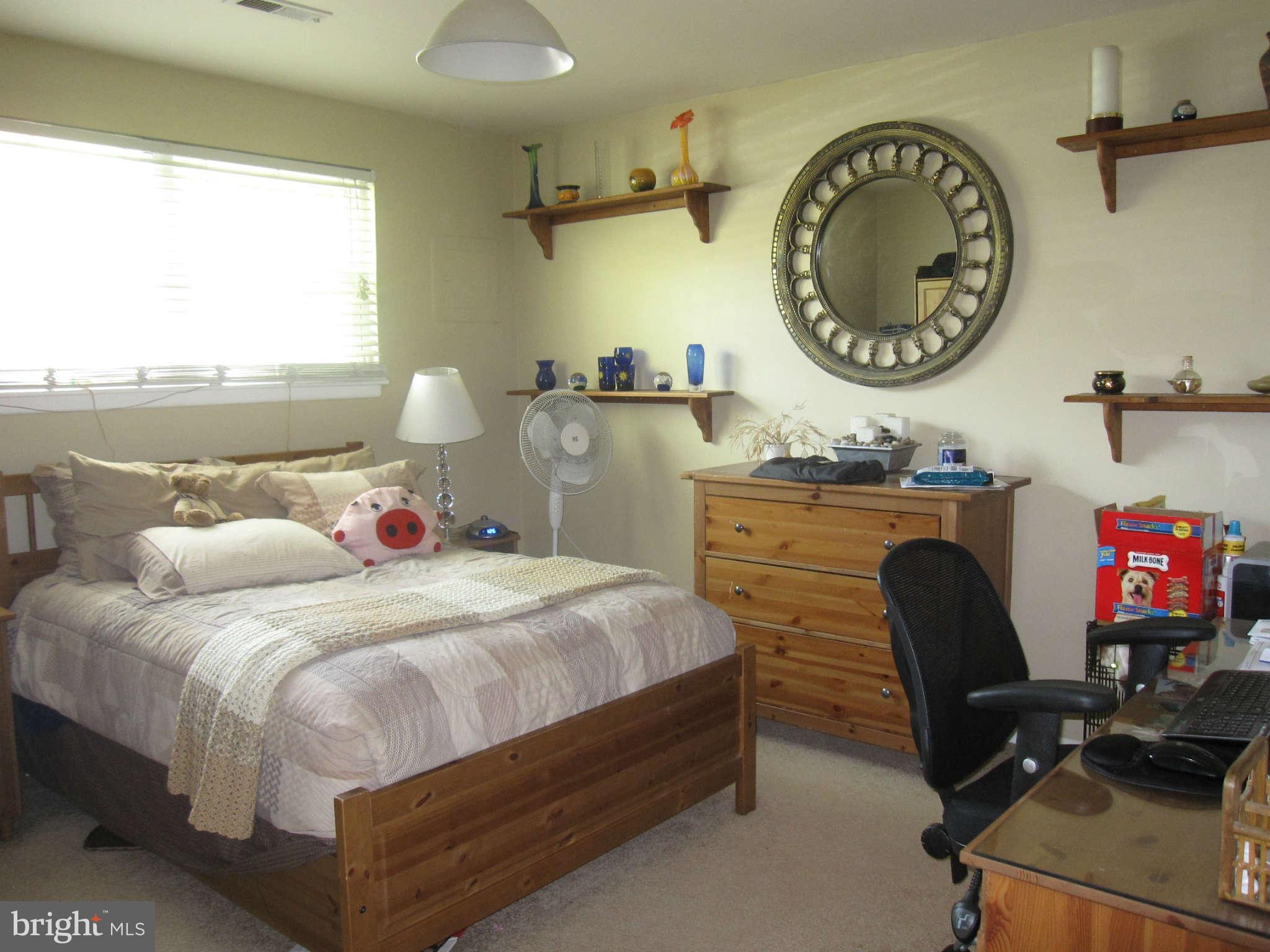 89 Valley Ridge Loop Cockeysville, MD 21030 - Photo 12 of 16 a bedroom with a bed a clock and a large window