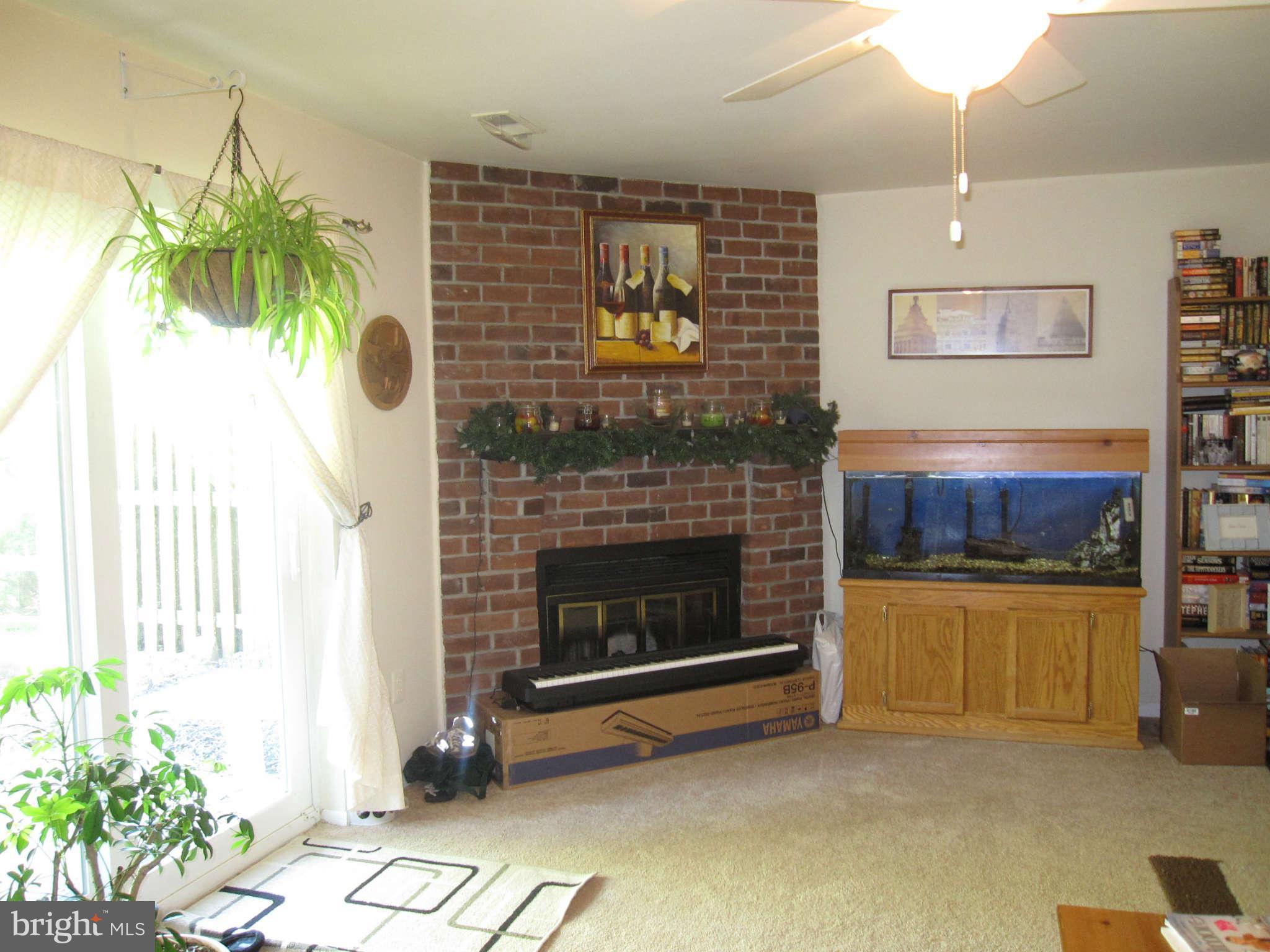 89 Valley Ridge Loop Cockeysville, MD 21030 - Photo 14 of 16 a living room with furniture and a fireplace
