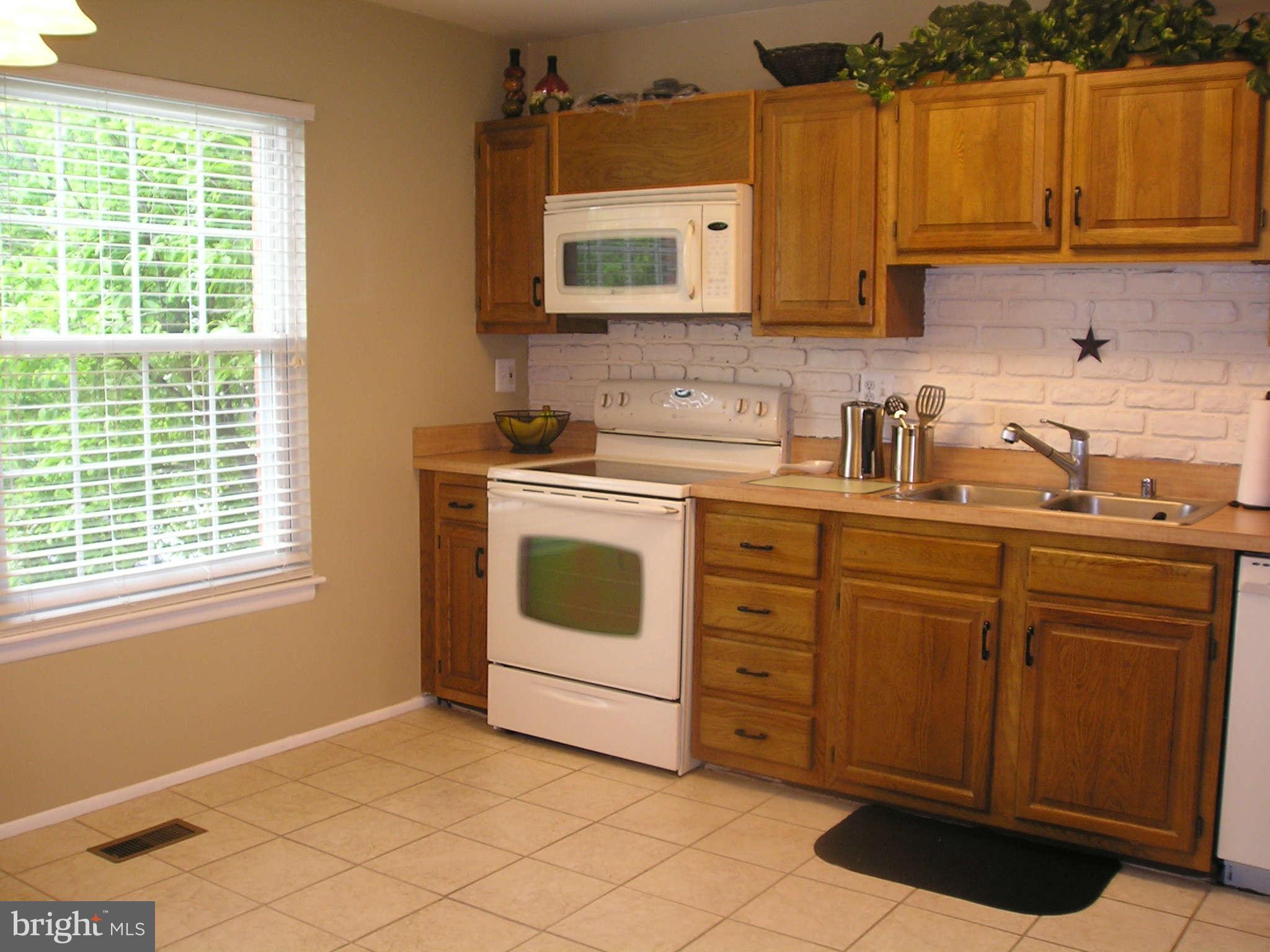 89 Valley Ridge Loop Cockeysville, MD 21030 - Photo 15 of 16 a kitchen with cabinets appliances a sink and a window
