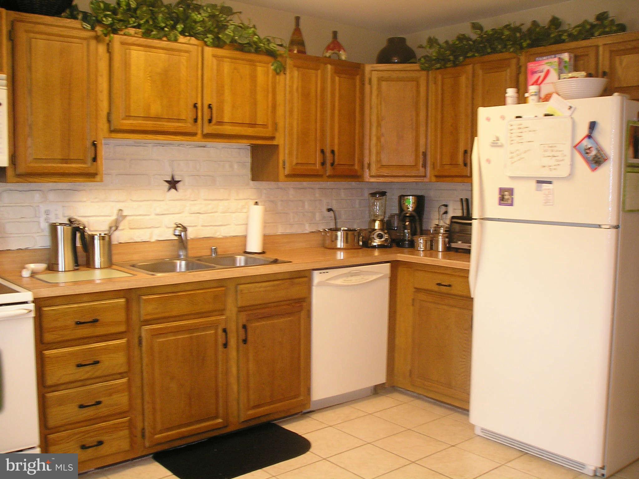 89 Valley Ridge Loop Cockeysville, MD 21030 - Photo 16 of 16 a kitchen with refrigerator and cabinets