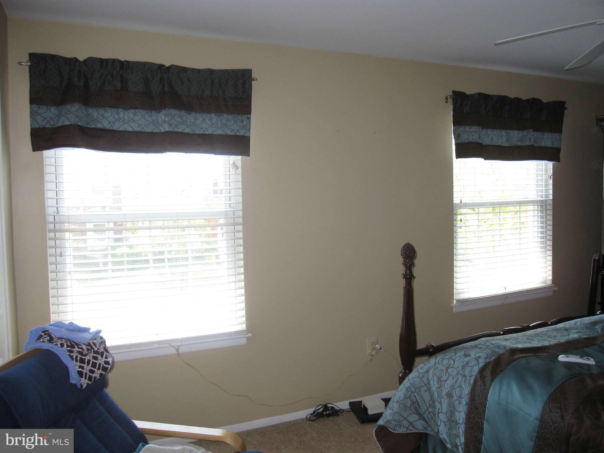 89 Valley Ridge Loop Cockeysville, MD 21030 - Photo 5 of 16 a bed sitting in a bedroom next to a window
