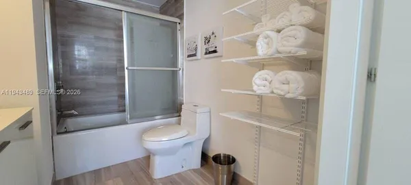 a bathroom with a toilet and a shower