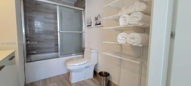 a bathroom with a toilet and a shower