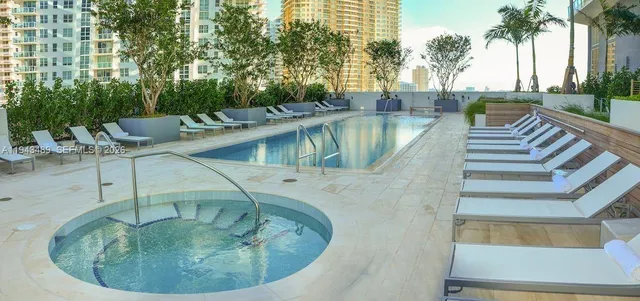 a view of a swimming pool with outdoor seating