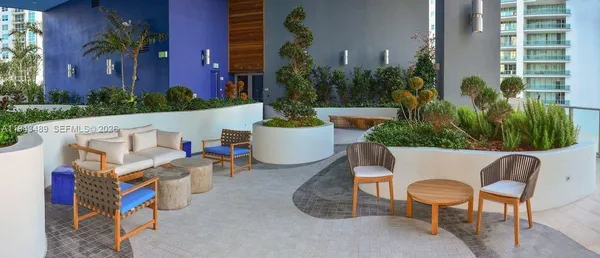 a view of a chairs and table in patio