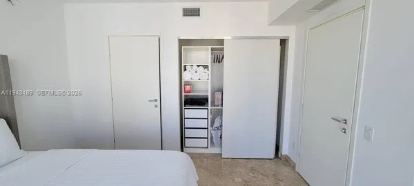 a bedroom with a bed and a closet