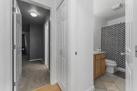 a bathroom with a toilet and a shower