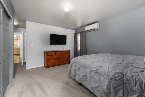 a bed room with a bed and a television