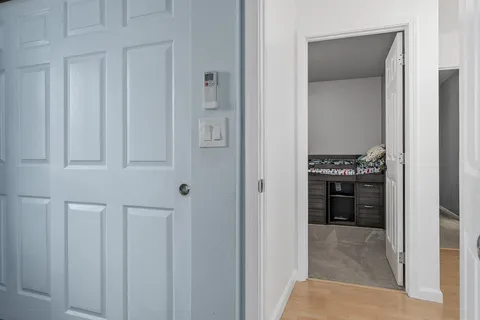 a kitchen with white cabinets and stainless steel appliances