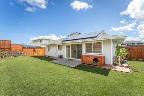 a front view of a house with a yard fire pit and outdoor seating