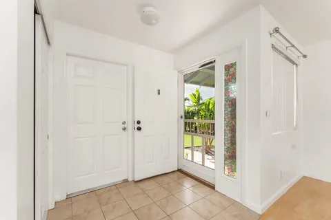 a view of an entryway with wooden floor