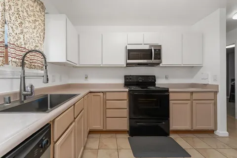 a kitchen with a sink stove and microwave
