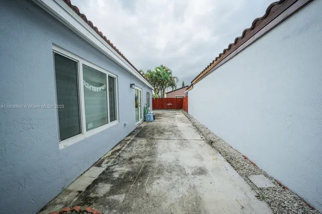 a view of backyard with a garden and palm trees