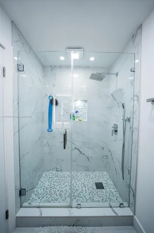 a bathroom with a sink mirror and toilet