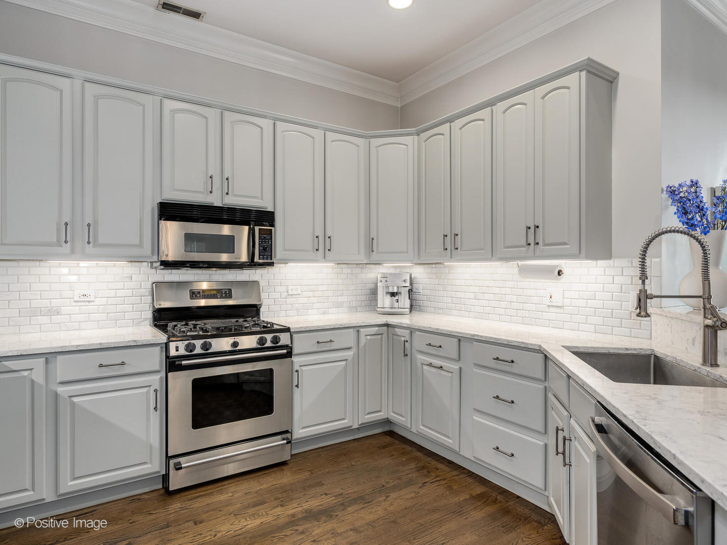 2030 North Halsted Street, Unit 2N Chicago, IL 60614 - Photo 14 of 26 a kitchen with white cabinets and white appliances