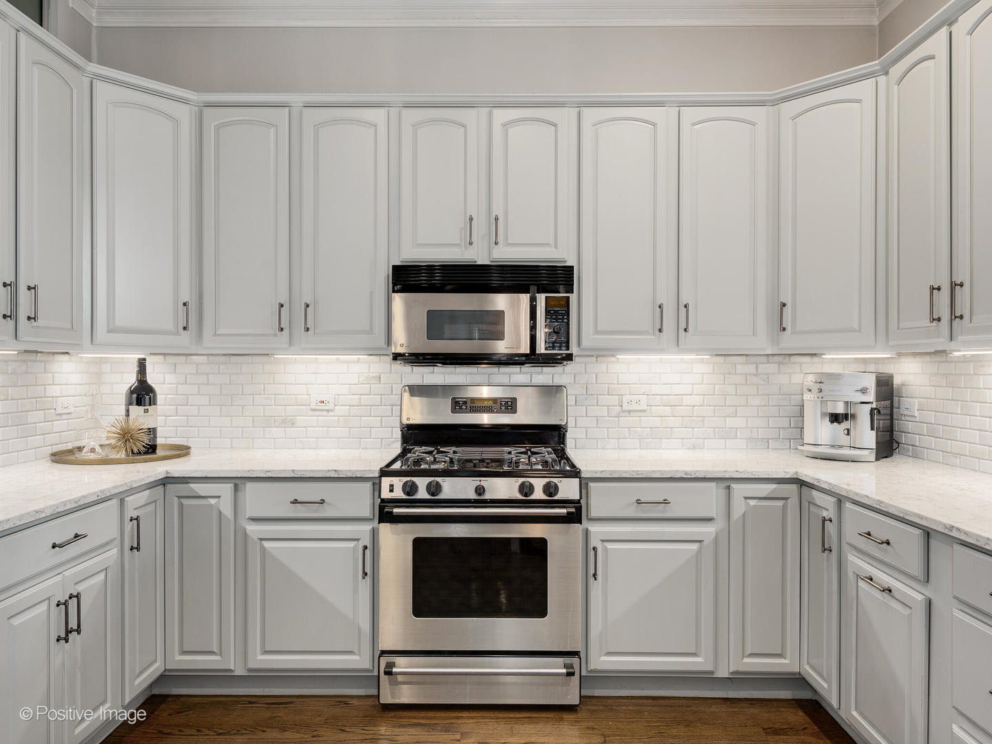 2030 North Halsted Street, Unit 2N Chicago, IL 60614 - Photo 15 of 26 a kitchen with granite countertop white cabinets and stainless steel appliances