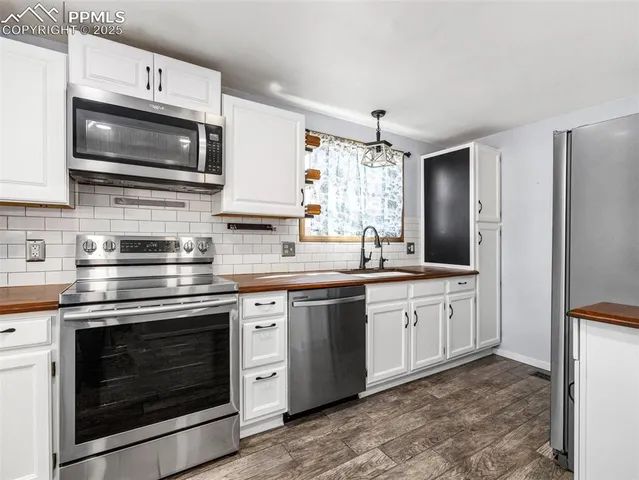 a kitchen with stainless steel appliances granite countertop a stove microwave and refrigerator