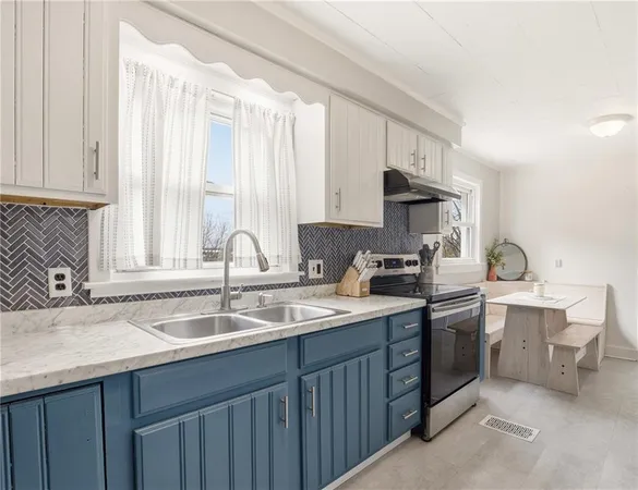 a kitchen with a sink stove and cabinets