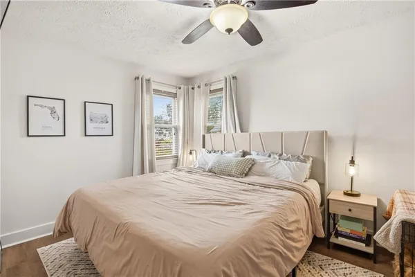 a bedroom with a bed and wooden floor