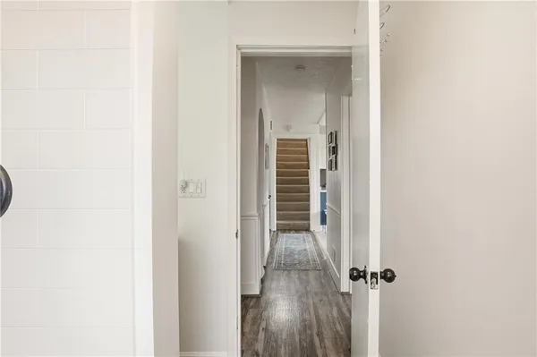 a view of a hallway with a wooden door