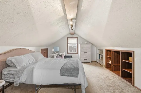 a spacious bedroom with a bed and a walk in closet