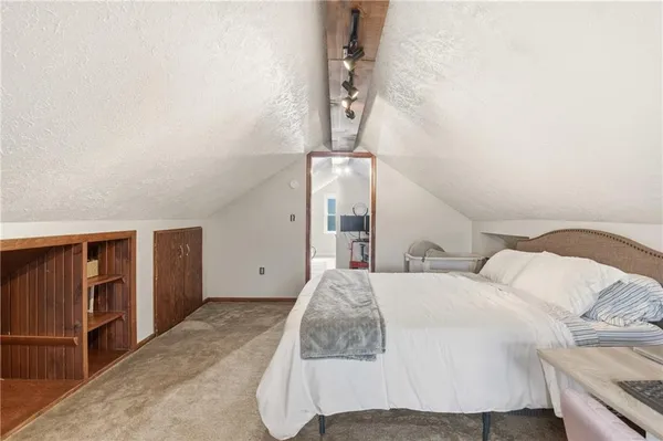 a bedroom with a bed and walk in closet