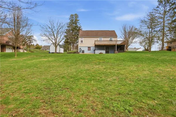 a backyard of a house with plants and trees