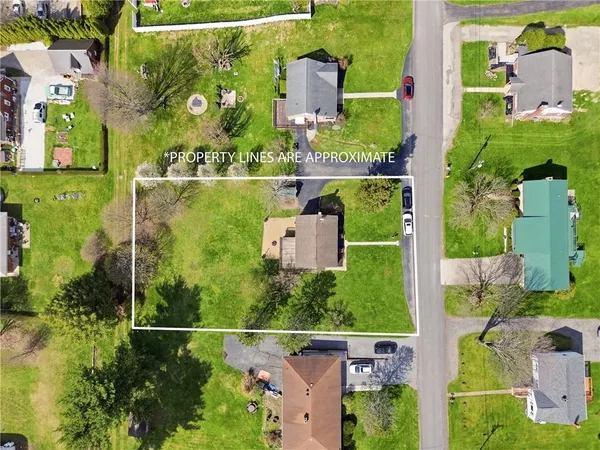 an aerial view of a house with a yard and lake view