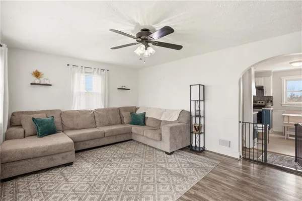 a living room with furniture and wooden floor