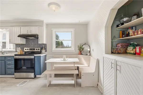 a kitchen with a stove and cabinets