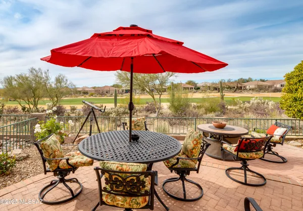 a view of a balcony with furniture and umbrella